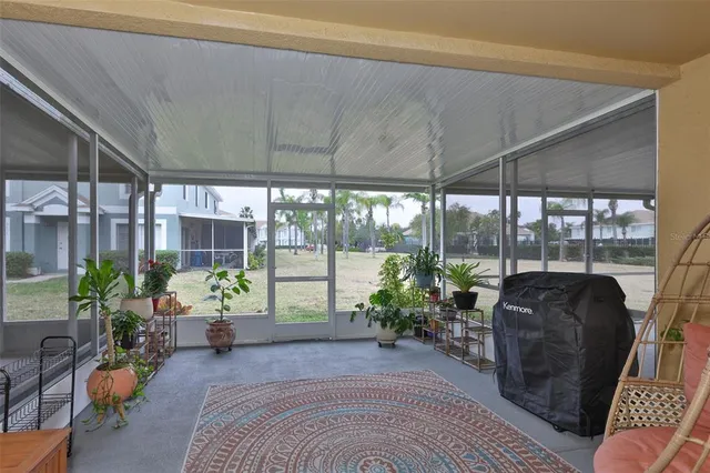 a living room filled with furniture and a potted plant