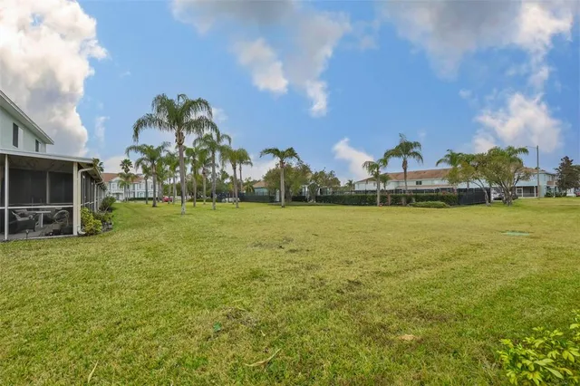 a view of a fountain in front of a house with a big yard
