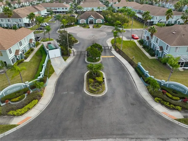 an aerial view of a house with a garden and swimming pool