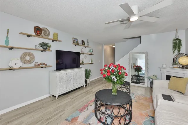 a living room with furniture and flowers