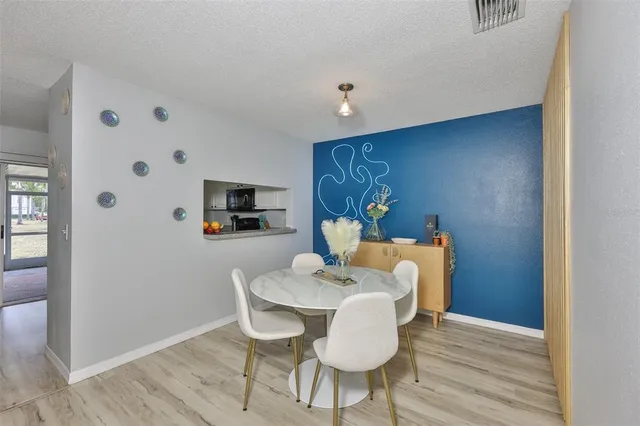 a view of a dining room with furniture and wooden floor