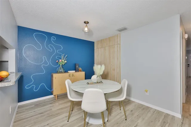 a view of a dining room with furniture and wooden floor