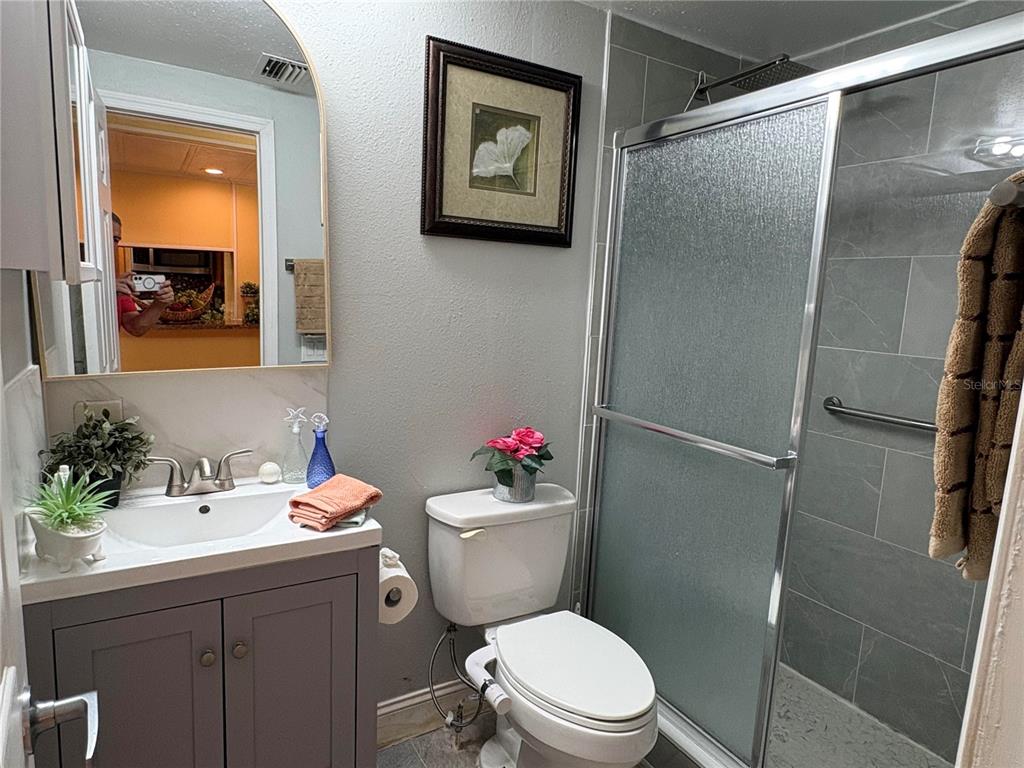 304 Eron Way, Unit 2 Winter Garden, FL 34787 - Photo 12 of 19 a bathroom with a sink mirror vanity and toilet