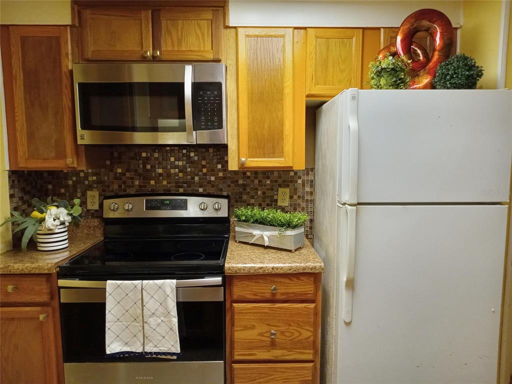 304 Eron Way, Unit 2 Winter Garden, FL 34787 - Photo 3 of 19 a kitchen with a refrigerator and a stove