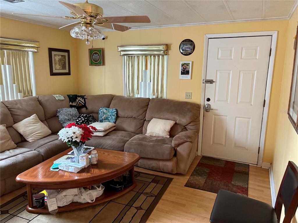 304 Eron Way, Unit 2 Winter Garden, FL 34787 - Photo 3 of 3 a living room with furniture flowerpot and a window
