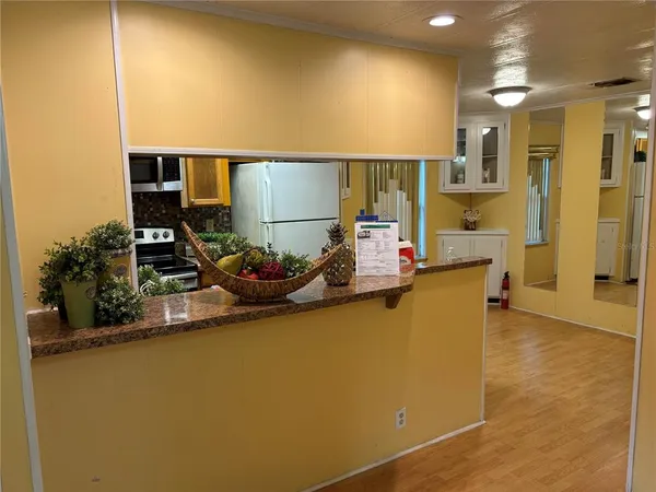 a kitchen with a refrigerator and a stove