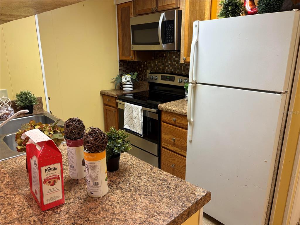 304 Eron Way, Unit 2 Winter Garden, FL 34787 - Photo 4 of 19 a kitchen with a refrigerator and a stove top oven