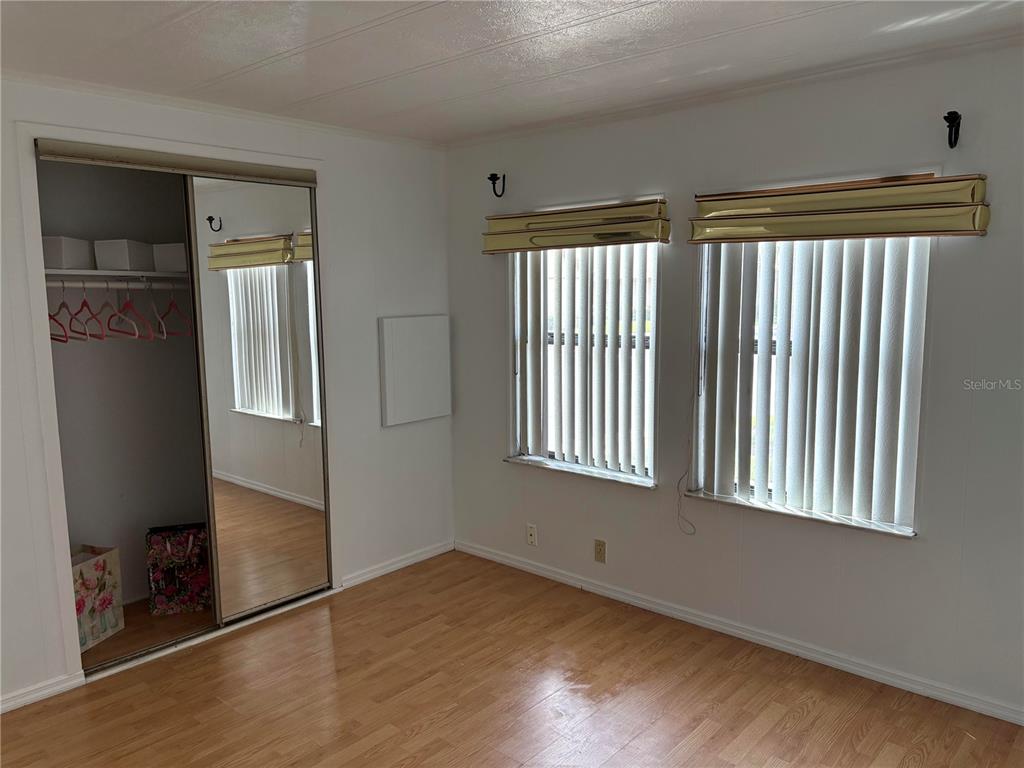 304 Eron Way, Unit 2 Winter Garden, FL 34787 - Photo 7 of 19 an empty room with wooden floor and windows