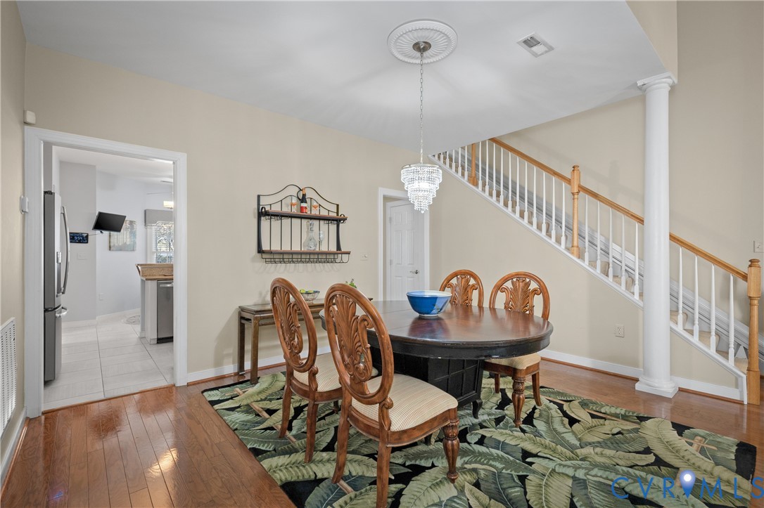 2205 Magnolia Grove Way Midlothian, VA 23113 - Photo 11 of 37 a view of a dining room with furniture and wooden floor