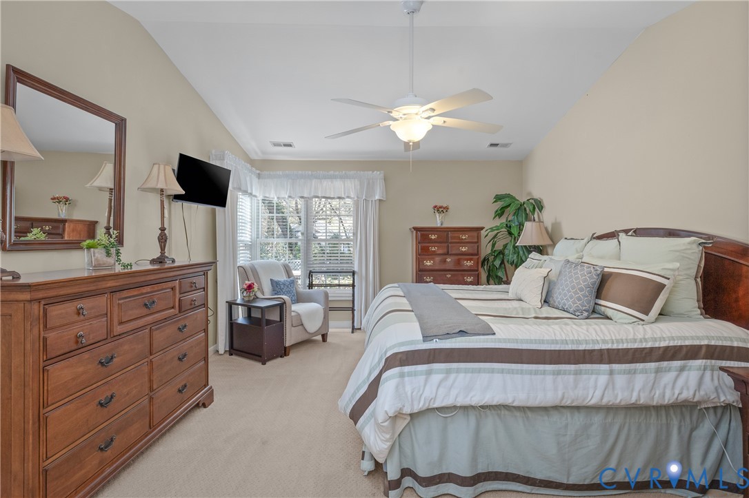 2205 Magnolia Grove Way Midlothian, VA 23113 - Photo 20 of 37 a bedroom with a large bed and a flat tv screen on dresser