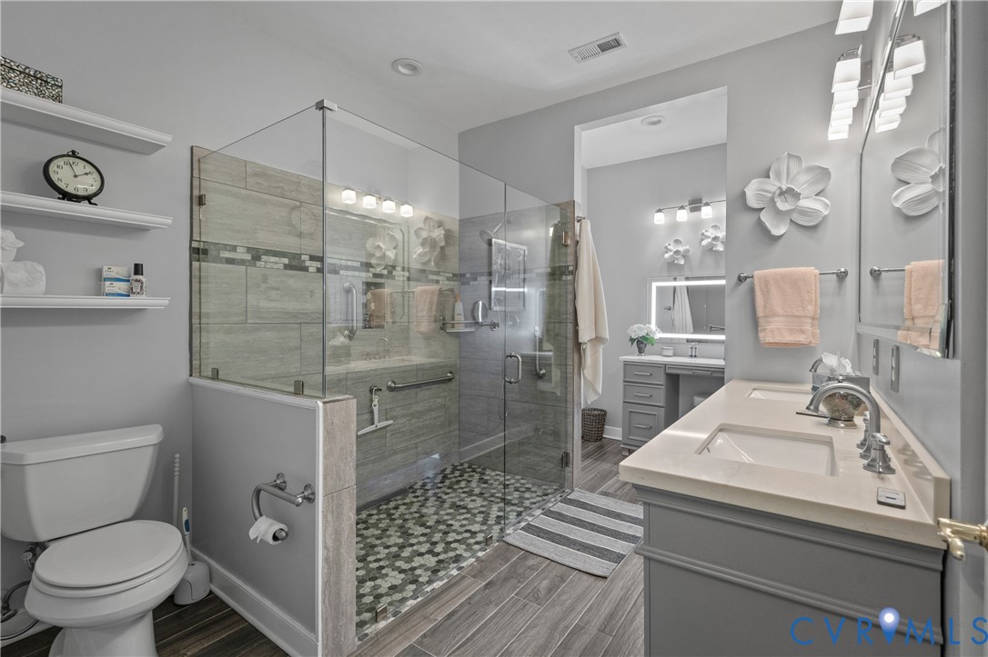 2205 Magnolia Grove Way Midlothian, VA 23113 - Photo 24 of 37 a bathroom with a sink a toilet and shower