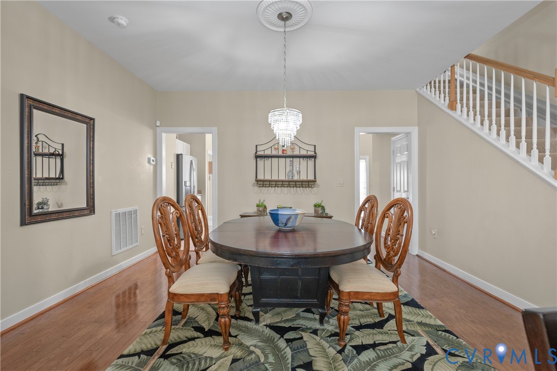 2205 Magnolia Grove Way Midlothian, VA 23113 - Photo 10 of 37 a view of a dining room with furniture and chandelier