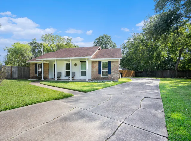 a view of house with outdoor space and garden