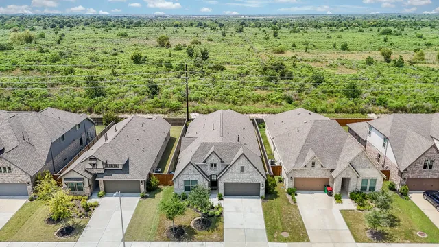 an aerial view of a house with a yard and lake view
