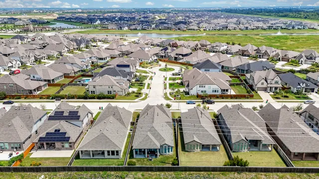 an aerial view of residential houses with outdoor space