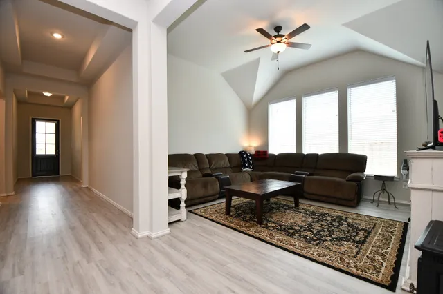 a living room with furniture rug and a chandelier