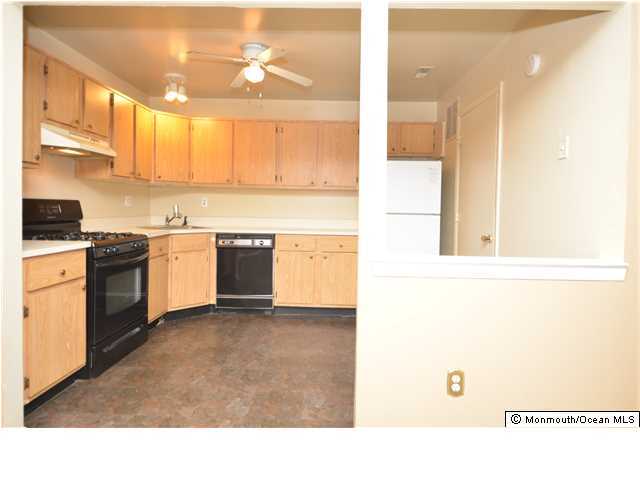 512 Harding Road, Unit 2 Freehold, NJ 07728 - Photo 5 of 12 a kitchen with stainless steel appliances granite countertop a stove a sink and a refrigerator