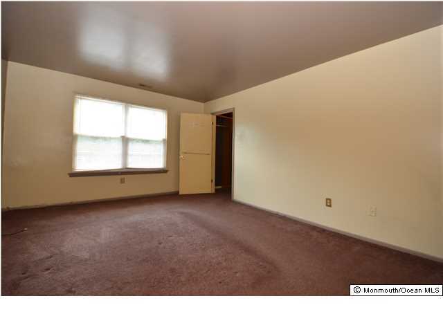 512 Harding Road, Unit 2 Freehold, NJ 07728 - Photo 6 of 12 a black and white photo of a big room