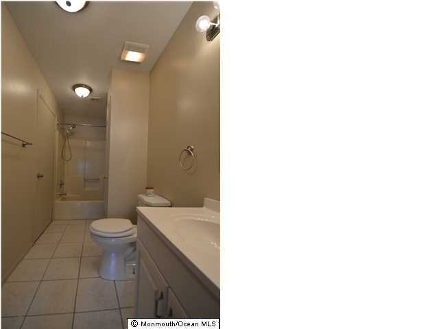 512 Harding Road, Unit 2 Freehold, NJ 07728 - Photo 7 of 12 a bathroom with a toilet a sink a shower and a mirror