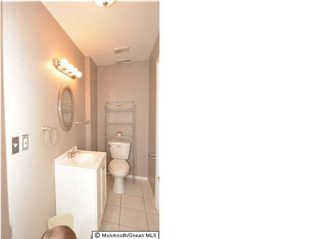 512 Harding Road, Unit 2 Freehold, NJ 07728 - Photo 8 of 12 a bathroom with a toilet a sink and mirror