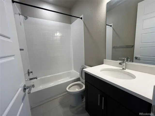 a living room with a piano and a chandelier