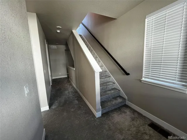 a terrace of a house with wooden floor outdoor seating
