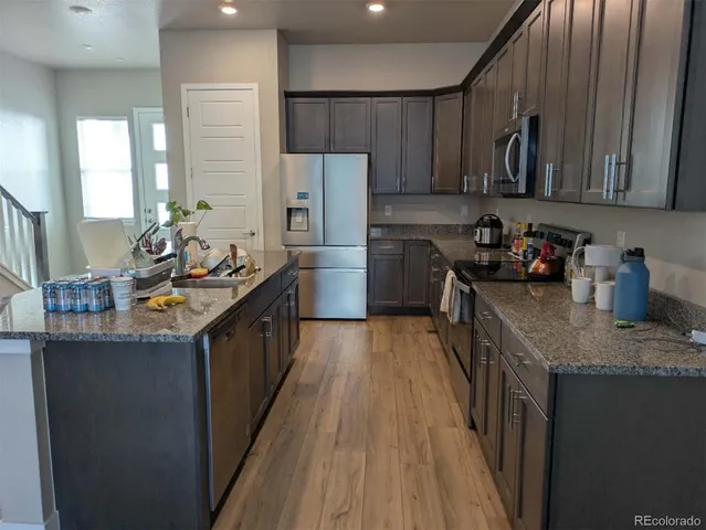 a view of a room with wooden floor and lounge chair