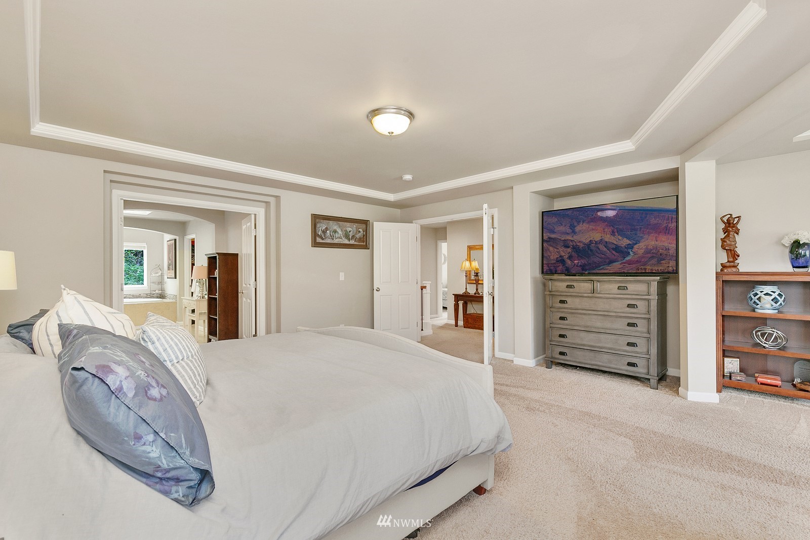 14114 163rd Place Southeast Renton, WA 98059 - Photo 16 of 33 a spacious bedroom with a bed a dresser and a large mirror