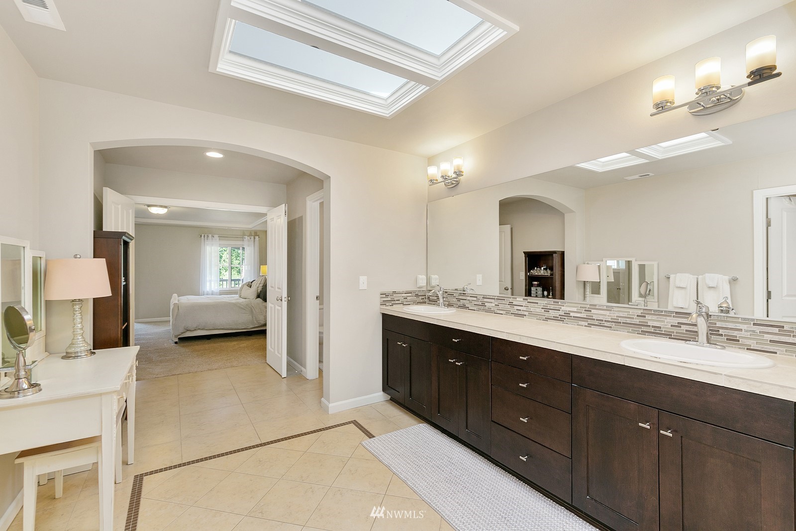 14114 163rd Place Southeast Renton, WA 98059 - Photo 18 of 33 a en suite bathroom with a double vanity sink and a mirror