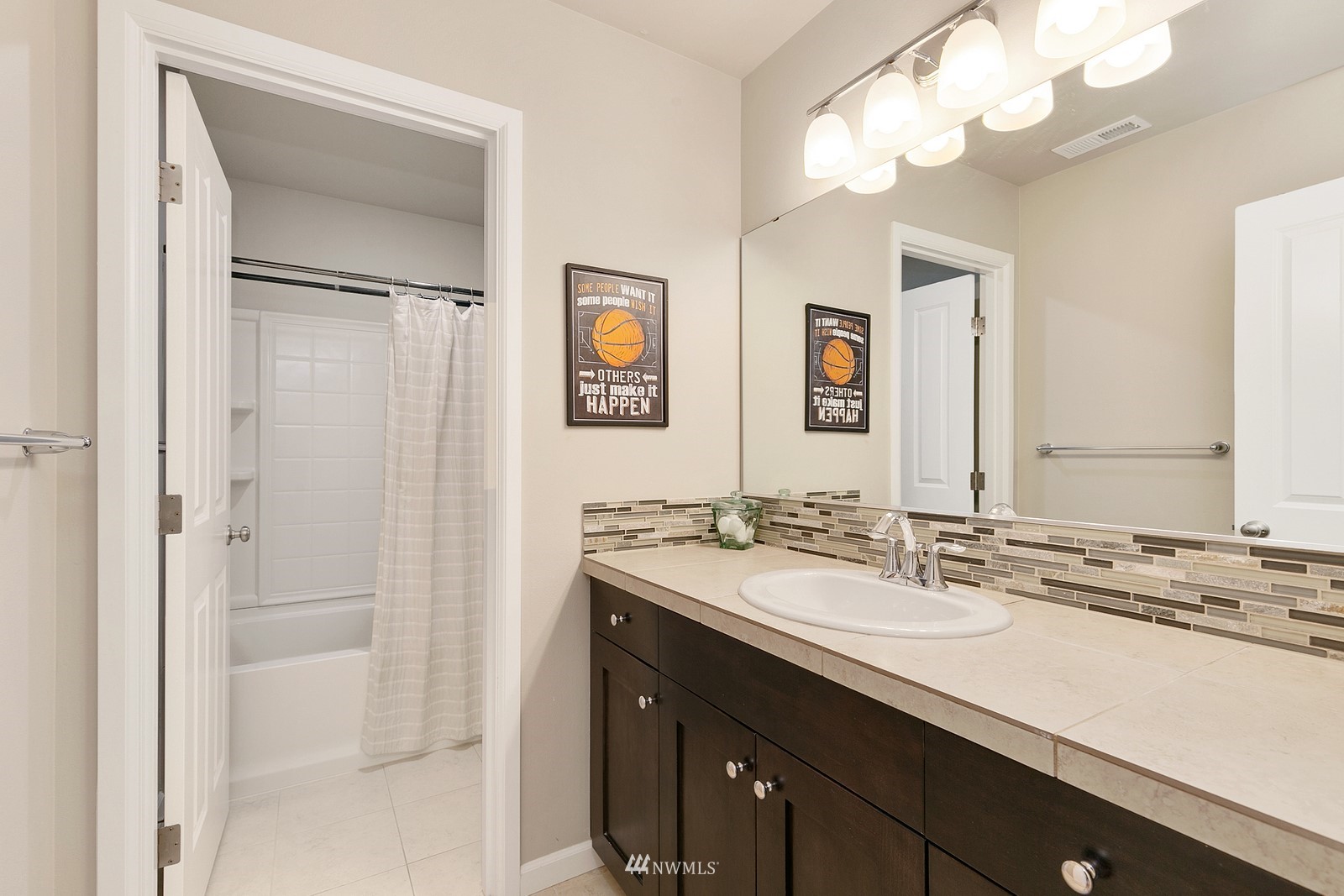 14114 163rd Place Southeast Renton, WA 98059 - Photo 21 of 33 a bathroom with a sink a vanity and a mirror