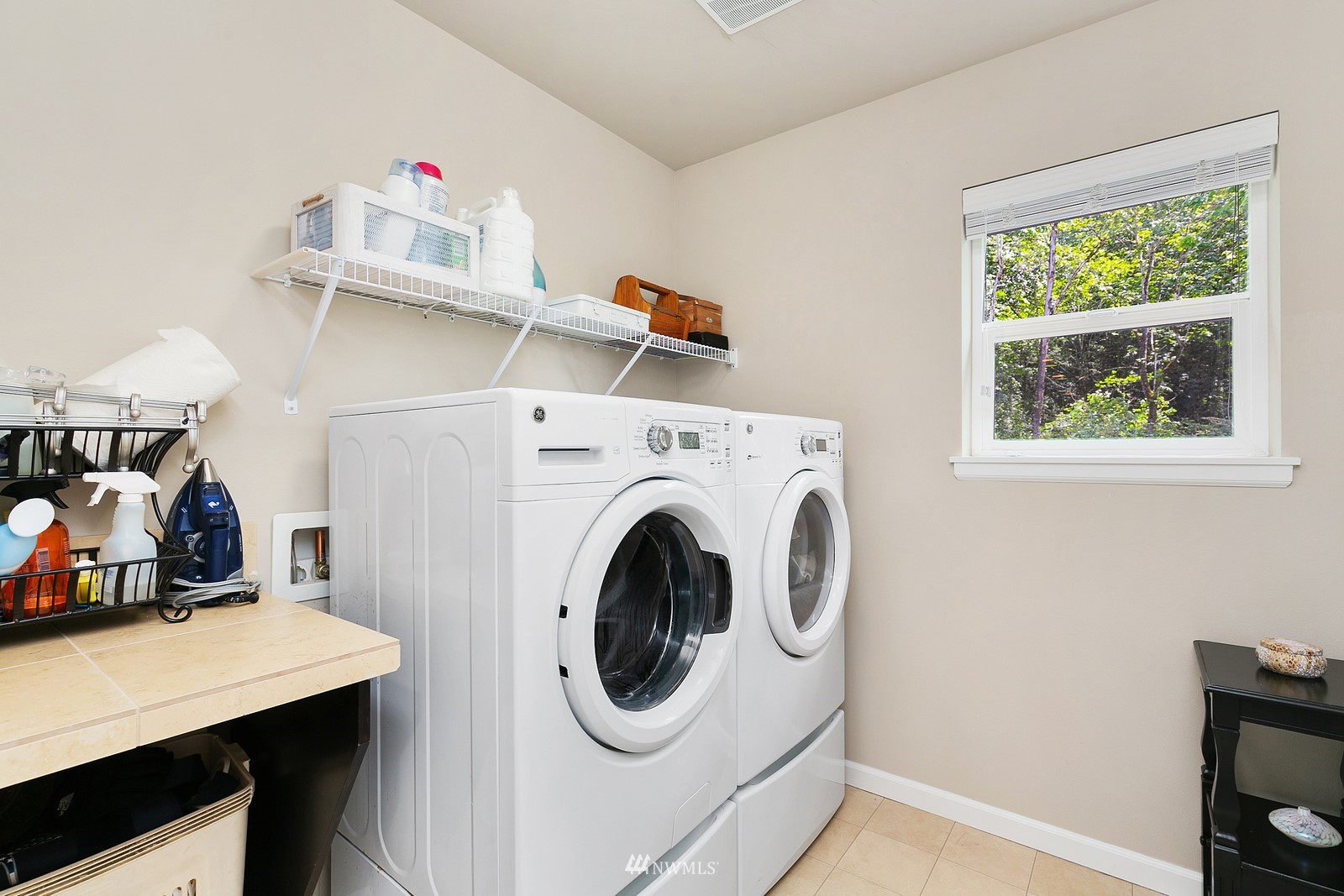 14114 163rd Place Southeast Renton, WA 98059 - Photo 23 of 33 a utility room with dryer washer and a fridge