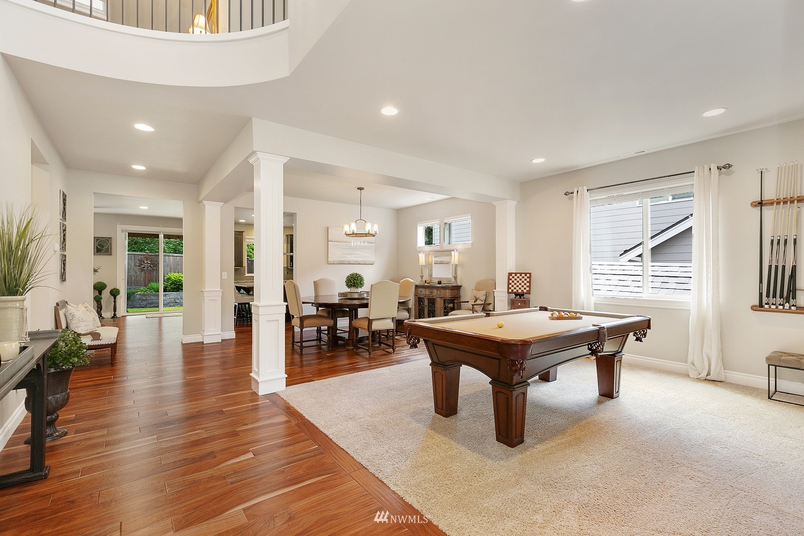 14114 163rd Place Southeast Renton, WA 98059 - Photo 3 of 33 a dining room with wooden floor a chandelier a wooden table and chairs