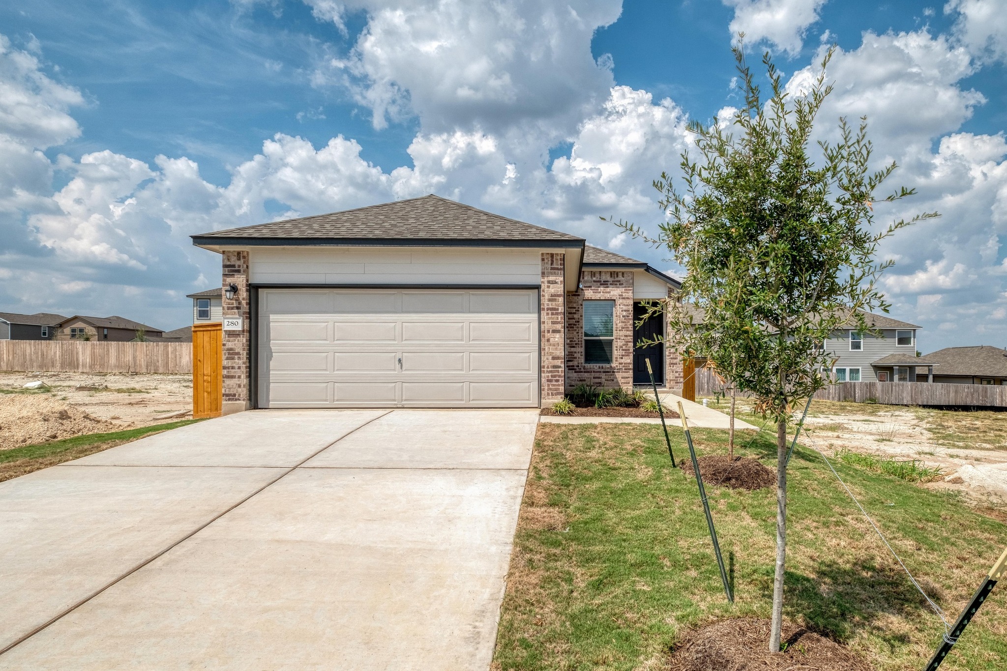 280 Feathers Street Jarrell, TX 76537 - Photo 2 of 26 a front view of a house with a yard and garage