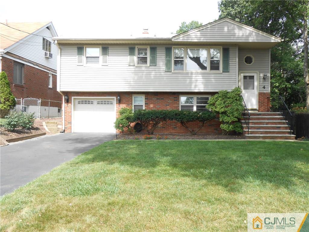 4 Maple Road Iselin, NJ 08830 - Photo 1 of 21 a front view of a house with a garden