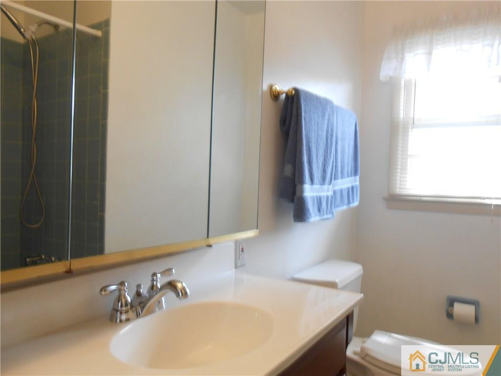 4 Maple Road Iselin, NJ 08830 - Photo 12 of 21 a bathroom with a sink and a toilet