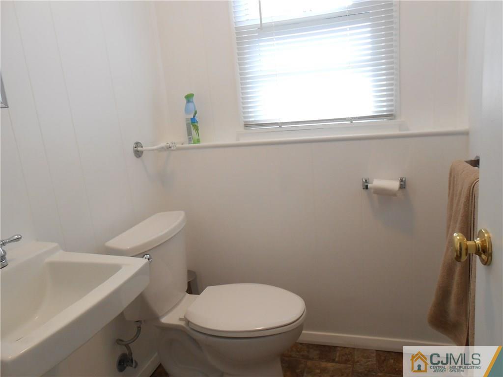 4 Maple Road Iselin, NJ 08830 - Photo 13 of 21 a white toilet sitting next to a bathroom sink