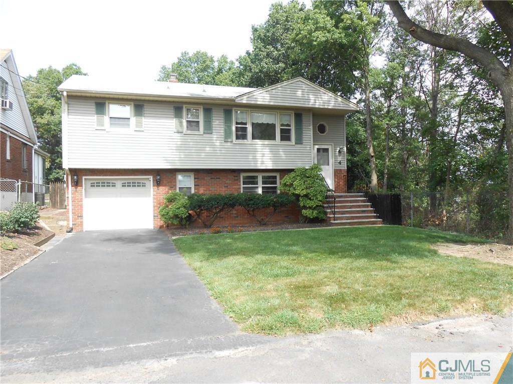 4 Maple Road Iselin, NJ 08830 - Photo 21 of 21 a front view of a house with a yard and garage