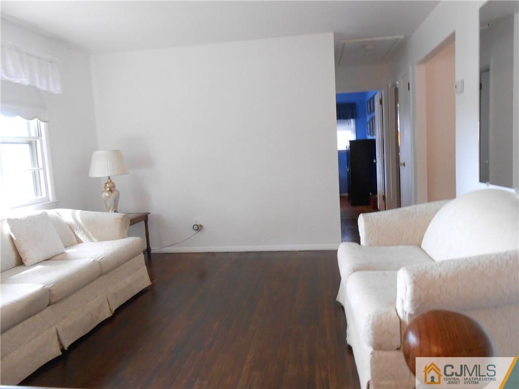 4 Maple Road Iselin, NJ 08830 - Photo 4 of 21 a living room with a couch and a coffee table