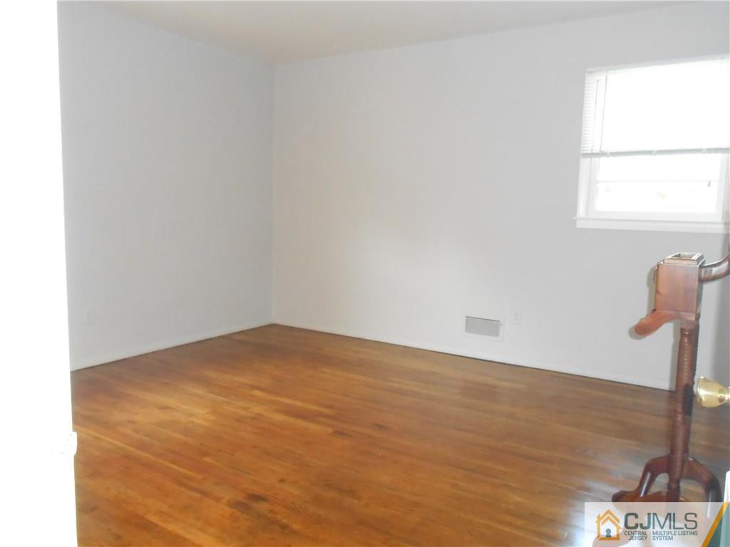 4 Maple Road Iselin, NJ 08830 - Photo 7 of 21 a view of empty room with wooden floor