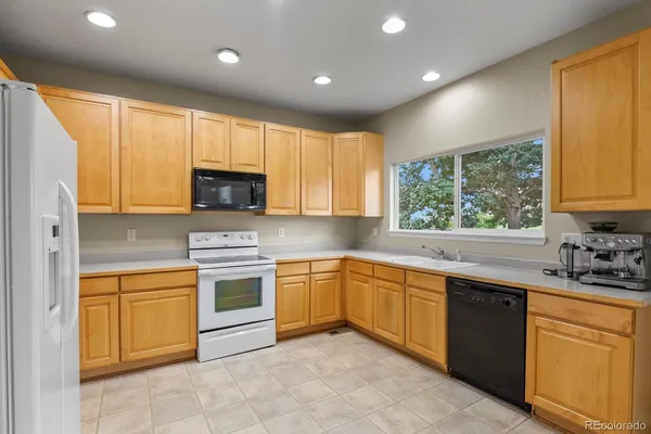 a kitchen with a sink stove and microwave