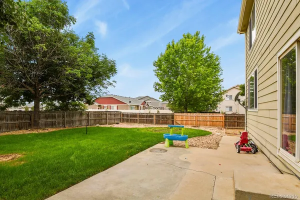 a view of a house with a yard and a garden