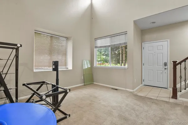 a view of a room with gym equipment and windows