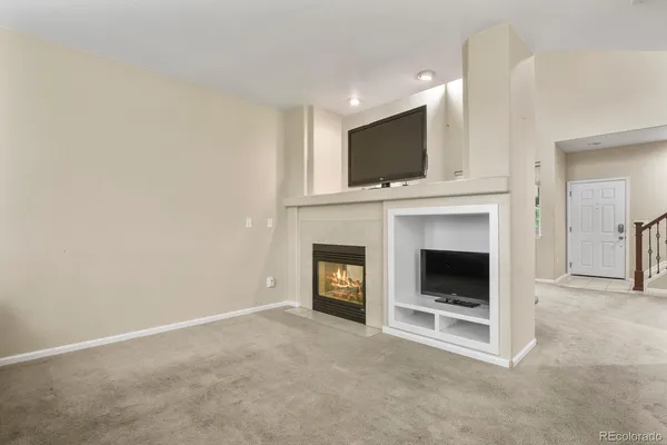 a living room with a fireplace and a flat screen tv