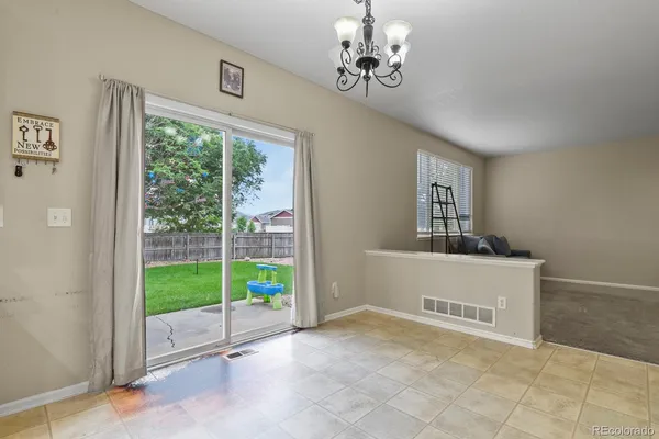 a view of a room with window and a ceiling fan