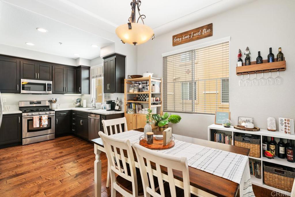 2178 Historic Decatur Road, Unit 31 San Diego, CA 92106 - Photo 1 of 1 a kitchen with stainless steel appliances granite countertop a stove a refrigerator a kitchen island a dining table and chairs