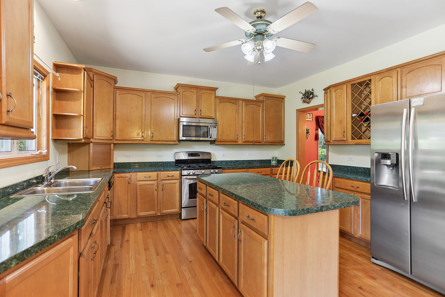 2708 High Meadow Road Naperville, IL 60564 - Photo 5 of 21 a kitchen with stainless steel appliances granite countertop a sink stove microwave and refrigerator