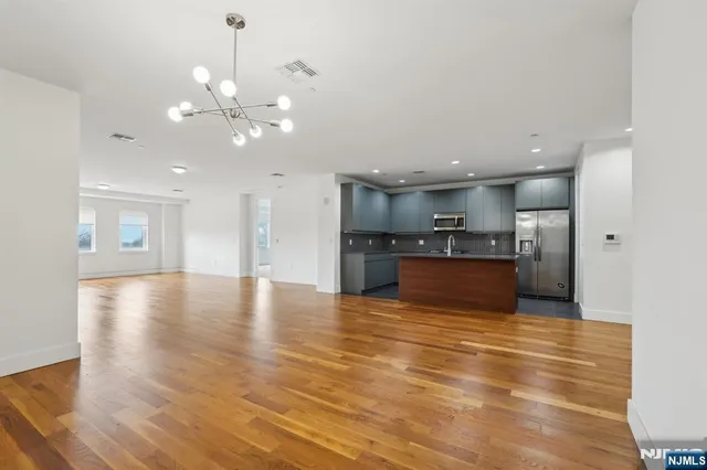 a view of kitchen and kitchen with a sink wooden floor kitchen view