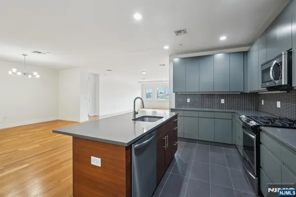 a kitchen that has a sink and a stove in it