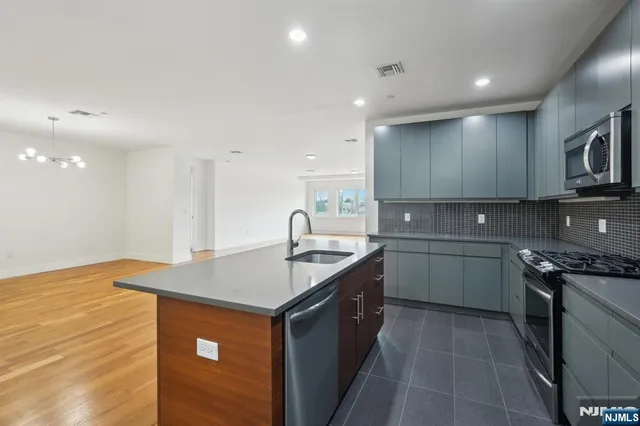 a kitchen that has a sink and a stove in it