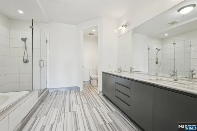 a bathroom with a double vanity sink and mirror